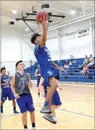  ?? Westside Eagle Observer/MIKE ECKELS ?? Tafari James (Decatur 13) puts up a layup during the third game of the Colcord scrimmage matches at Earp Gym in Colcord, Okla., on June 21.