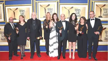  ??  ?? (Left to right) Writers Jonathan Igla, Semi Chellas, Robert Towne, Janet Leahy, Carly Wray, Matthew Weiner, Erin Levy, Lisa Albert, and Tom Smuts, winners of the Drama Series award for ‘Mad Men’, pose during the 2016 Writers Guild Awards at in Los Angeles, California. — AFP file photo