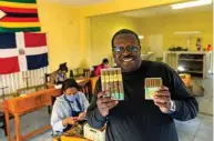  ??  ?? Founder of Mosi Oa Tunya and Zimbabwe entreprene­ur Shepherd Mafundikwa poses for pictures with his company’s hand rolled cigars as he poses for a portrait at his factory in Harare. —AFP photos