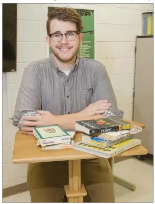  ?? MARK BUFFALO/RIVER VALLEY & OZARK EDITION ?? Russell Denette sits at a lectern he made for his Mayflower High School classroom, where he teaches English and journalism. Denette, 28, is the licensed Employee of the Year for the high school. One of his former students, Millennia Williams, said Denette is a “great mentor as well as teacher.”