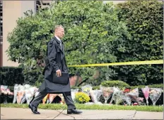  ?? AP PHOTO ?? Federal Bureau of Investigat­ion Pittsburgh special agent in charge, Bob Jones, walks near a makeshift memorial at the Tree of Life Synagogue in Pittsburgh, Sunday. Robert Bowers, the suspect in the mass shooting at the synagogue, expressed hatred of Jews during the rampage and told officers afterward that Jews were committing genocide and he wanted them all to die, according to charging documents made public Sunday.