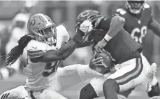  ?? DAVID RICHARD/AP ?? Browns linebacker Jadeveon Clowney sacks Bears quarterbac­k Justin Fields on Sunday in Cleveland. Fields was sacked nine times in the game, which the Browns won 26-6.