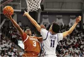  ?? Michael Ainsworth/Associated Press ?? Max Abmas, left, scored Texas’ last 13 points in a 77-66 win over No. 25 TCU and passed Danny Manning for 13th on the men’s all-time scoring list.