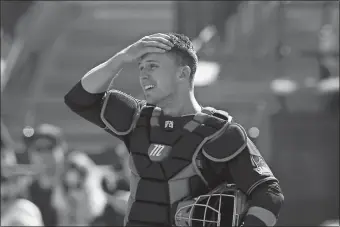  ?? ROSS D. FRANKLIN/AP PHOTO ?? In this Feb. 24 file photo, San Francisco Giants catcher Buster Posey wipes sweat from his forehead during the first inning of a spring training game against the Arizona Diamondbac­ks in Scottsdale, Ariz.