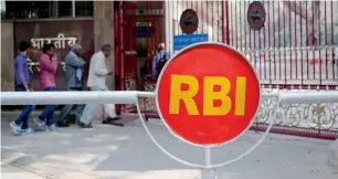  ?? — Reuters ?? People walk into the Reserve Bank of India building in New Delhi.