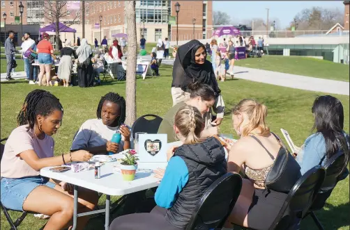  ?? (Ap/giovanna Dell’orto) ?? Sadaf Shier (standing), the Muslim chaplain at the University of St. Thomas, talks May 7 with students attending the school’s celebratio­n for the end of the Muslim holy month of Ramadan in St. Paul, Minn. She helped organize the event, which included several stress-reducing activities for students of any or no faith, as part of a broadening of the mission of campus ministry to address holistic student well-being.