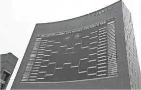  ?? BARBARA J. PERENIC/USA TODAY SPORTS ?? Filling out an NCAA Tournament bracket has become a tradition in many offices.