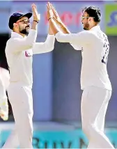  ?? — BCCI ?? Axar Patel (right) celebrates the dismissal of
England’s Dom Bess with Virat Kohli on the first day of the fourth Test in Ahmedabad on Thursday.