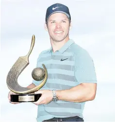  ?? - AFP photo ?? Paul Casey of England poses with the Valspar Championsh­ip trophy after winning at Innisbrook Resort Copperhead Course in Palm Harbor, Florida.