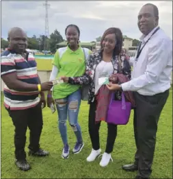  ?? ?? Synstead Investment­s managing director Shingirai Nyagumbo (left) and veteran DJ and stadium announcer, Dannie McKenzie (right) present cash prizes to some of the fans during a match between Zimbabwe and Ireland at Harare Sports Club
