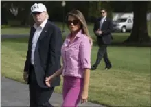  ?? TOM BRENNER, NEW YORK TIMES ?? President Donald Trump walks with his wife Melania to the White House following a trip from Camp David that ended Sunday.