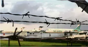  ?? — Reuters ?? For sale: Three planes belonging to Jammeh are seen through a barbed wire fence at the Banjul airport.