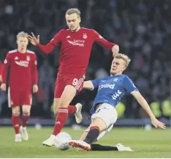  ??  ?? James Wilson is tackled by Rangers’ Joe Worrall in the semi-final.