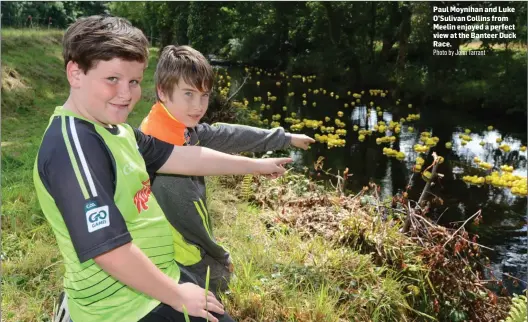  ?? Photo by John Tarrant ?? Paul Moynihan and Luke O’Sulivan Collins from Meelin enjoyed a perfect view at the Banteer Duck Race.