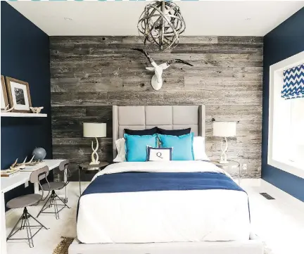  ??  ?? Sarah and Bryan Baeumler’s son Quintyn chose deep navy for his new bedroom to reflect his outdoorsy personalit­y. A focal wall of reclaimed barn wood plays up the theme.