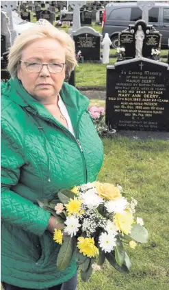  ??  ?? Helen Deery at the grave of her brother Manus yesterday in Londonderr­y. Manus was shot dead on May 19, 1972