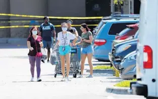  ?? RICARDO RAMIREZ BUXEDA/ORLANDO SENTINEL ?? Shoppers wear masks at Walmart on south Goldenrod Road Wednesday. The 32822 ZIP code is a hot spot with the most cases of the coronaviru­s in Orange County.