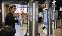  ?? CHARLES REX ARBOGAST / ASSOCIATED PRESS ?? Brandon Alba of Milwaukee orders from a digital ordering kiosk at a McDonald’s restaurant in Chicago. McDonald’s is making changes to increase food delivery speed.
