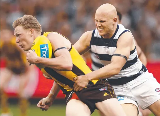  ?? Picture: AAP IMAGE ?? CHAMPION: James Sicily of the Hawks is tackled by Gary Ablett as the Cats ran away in their clash at the MCG yesterday. Ablett shrugged off controvers­y over his ‘liking’ of a controvers­ial Israel Folau social media post to dominate up front.