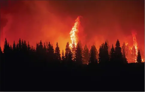  ?? NOAH BERGER — THE ASSOCIATED PRESS ?? Flames from the Dixie Fire crest a hill July 26in Lassen National Forest near Jonesville, Oregon.