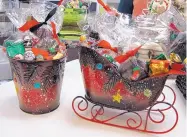  ??  ?? Holiday gift packages from Theobroma Chocolatie­r bring cheer to any event.