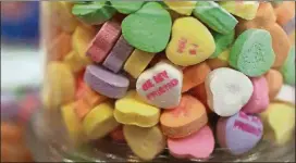  ?? JOE RAEDLE/GETTY IMAGES ?? Sweetheart candy hearts are seen on the shelf at the To The Moon Marketplac­e in Wilton Manors, Fla. The store stocked up early after the owners learned Necco had filed for bankruptcy.