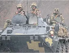  ?? ?? Ukrainian soldiers in an armoured vehicle in Donetsk.