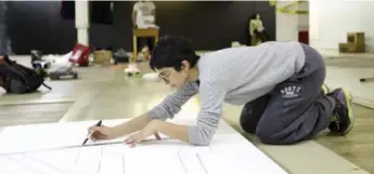  ??  ?? Artist in residence Romana Kassam works on cutting out some styrofoam.