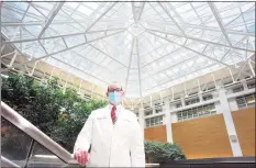  ?? Ned Gerard / Hearst Connecticu­t Media ?? Dr. Rob Fogerty in the main atrium of Yale New Haven Hospital in New Haven on Friday. Fogerty is director of bed resources at the hospital.