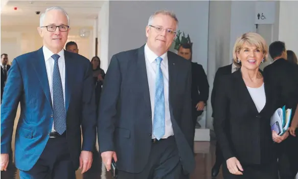  ??  ?? Malcolm Turnbull, Scott Morrison and Julie Bishop walk to the House of Representa­tives Chamber yesterday morning after losing the support of Mathias Cormann.