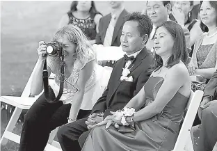  ?? Jonathan Elderfield/Jonathan Elderfield Photograph­y via AP ?? right Wedding photograph­er Andi Schreiber, left, documents the wedding ceremony of Jennifer Chen and Tony Tran on June 20, 2010, at Wainwright House in Rye, New York.