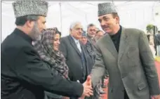  ?? PTI FILE ?? Former J&K chief minister and Congress leader Ghulam Nabi Azad (right) greets state’s former deputy CM and PDP leader Muzaffar Hussain Baig (left) in 2007.