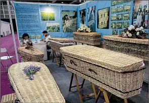  ?? AP/VINCENT YU ?? Wicker and seagrass coffins are displayed at the Asia Funeral and Cemetery Expo & Conference last week in Hong Kong.