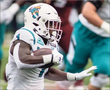  ?? Vasha Hunt / Associated Press ?? Coastal Carolina running back CJ Marable (1) runs the ball during the first half of an NCAA football game on Saturday in Troy, Ala. Coastal Carolina cracked the Associated Press’ top 10 on Sunday.