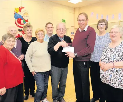  ??  ?? Presentati­on Service users at the West Calder Friendship cafe for patients with dementia, Alzheimer’s and other conditions handed over an early Christmas present. At their Christmas tea last week a cheque for £600 was given to Alan Midwinter of...