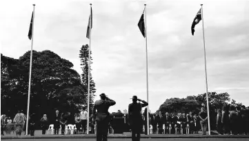  ?? — Reuetrs photo ?? Members of the Australian Defence Forces salute as the Aboriginal and Torres Strait Islander flags are raised along with the New South Wales and Australian national flags during a ceremony at Government House in Sydney, Australia.