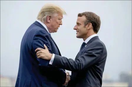  ?? ANDREW HARNIK — THE ASSOCIATED PRESS ?? President Donald Trump and French President Emmanuel Macron greet each other at the G-7 summit before a dinner at the Lighthouse of Biarritz, France, Saturday.