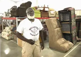  ?? Times Record News via AP ?? ■ Leon Green, founder of Disaster Helping Hands, stands Sept. 3 within the organizati­on’s new warehouse in Wichita Falls, Texas, where furniture and household goods are at the ready for the next time disaster strikes a community. While Wichita Falls...