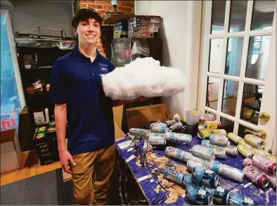  ?? Brian A. Pounds/Hearst Connecticu­t Media ?? Staples High junior Aiden Schachter, 16, has been growing his home business, LED Cloud Light, for three years. Schacter uses glued together aluminum cans to create the internal cloud structure of his lights.