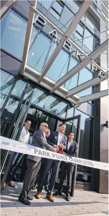  ??  ?? Qualex-Landmark president Mohammed Esfahani and Coun. Evan Woolley cut the ribbon to officially open Park Point.