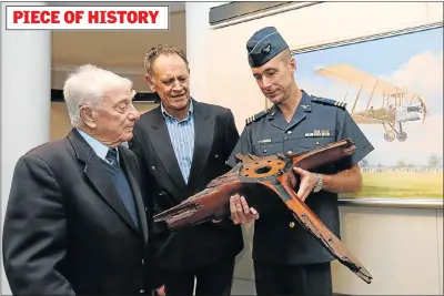  ?? Picture: WERNER HILLS ?? DAMAGED PROP: At the function to commemorat­e the landing of the first flight in Port Elizabeth 100 years ago are, from left, World War 2 veteran Colin Trader, 95, PE Golf Club president Bernhard Nagel and Captain Mark Kelbrick of the SAAF Museum, with...