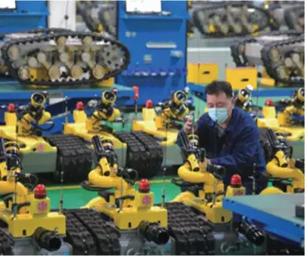  ??  ?? A robot workshop in the hi-tech industrial zone in Tangshan, Hebei Province in north China, on April 29