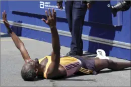  ?? AP photo ?? Sisay Lemma, of Ethiopia, celebrates while lying down after winning the Boston Marathon Monday in Boston.