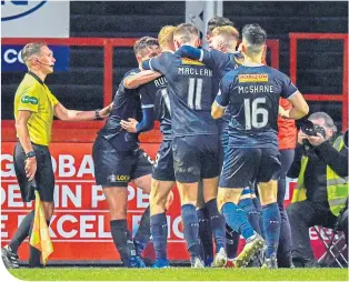  ??  ?? The Falkirk players celebrate Zak Rudden’s equaliser at Firhill