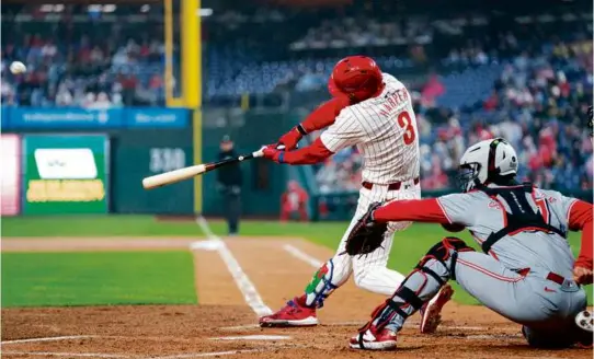  ?? CHRIS SZAGOLA/ASSOCIATED PRESS ?? Bryce Harper connected for three home runs — two solo shots, grand slam — in the Phillies’ win over the visiting Reds.