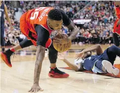  ??  ?? Toronto Raptors guard Delon Wright collects a loose ball after wrestling with Memphis Grizzlies guard Wayne Selden during NBA action Sunday at the ACC.