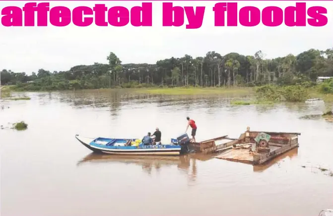  ??  ?? Navigating the floodwater:
Villagers of Yakishuru in Region One (Barima-Waini) amid the heavy flooding that has occurred in the area.