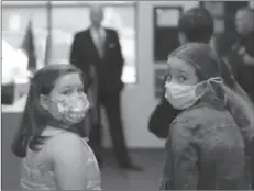  ??  ?? NEW JERSEY
Two Camden Elementary School students in masks listen as South Carolina Gov. Henry McMaster talks about steps the school is taking to fight COVID-1 in Camden, S.C. -AP