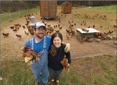  ?? MARK HOFFMAN/MILWAUKEE JOURNAL SENTINEL FILE PHOTOGRAPH ?? Chris Holman and his wife, Maria Davis, raise chickens and ducks for meat and eggs, in addition to hogs and growing produce on their 40-acre farm in Portage County. They are shown May 4 in Custer, Wis.