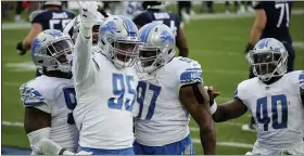  ?? BEN MARGOT — THE ASSOCIATED PRESS ?? Detroit Lions defensive end Romeo Okwara, center, celebrates after sacking Tennessee Titans quarterbac­k Ryan Tannehill for a safety during Sunday’s road loss. He was one of the Lions’ few bright spots in the game along with productive receiver Marvin Jones.